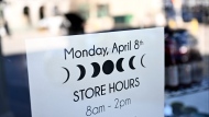 A graphic of an eclipse is seen on a business's special store hours, a day before a total solar eclipse will be visible in Kingston, Ont., Sunday, April 7, 2024. THE CANADIAN PRESS/Justin Tang