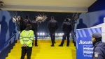 FILE - In this Sunday, Dec. 17, 2023, file photo, Greek police secure an entrance of a stadium during a Greek super League soccer match between Atromitos and Panathinaikos, at Peristeri stadium, in Athens, Greece. Greek authorities on Tuesday, April 9, 2024, have launched a ban on paper tickets at all top flight soccer matches as part of an effort to crack down on violence that has plagued the sport for decades. (AP Photo/Yorgos Karahalis, File)
