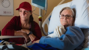 Michele Campeau, left, visits with her mother, Ruth Poupard, 83, at Hotel-Dieu Grace Healthcare where she is recovering from a broken hip, in Windsor, Ont., on Wednesday, April 3, 2024. Poupard also suffers from dementia and requires 24-hour care. THE CANADIAN PRESS/Dax Melmer
