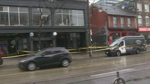 Police respond to a triple shooting at Queen and Portland streets in downtown Toronto Thursday April 11, 2024. 