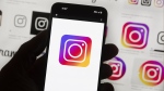 File - The Instagram logo is seen on a cell phone in Boston, USA, Oct. 14, 2022. Instagram says it’s testing out new tools to protect young people and combat sexual extortion, including a feature that will automatically blur nudity in direct messages. (AP Photo/Michael Dwyer, File)