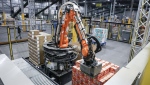 A robot unloads a pallet of cat food at a Walmart distribution centre in Calgary, Thursday, March 28, 2024. Walmart Canada is planning to bring robots to two Ontario distribution centres. THE CANADIAN PRESS/Jeff McIntosh