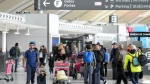 People are shown at Pearson International Airport in Toronto on Friday, March 10, 2023. Toronto's airport authority is planning to invest in Pearson Airport as it expects to welcome more visitors every year. THE CANADIAN PRESS/Nathan Denette