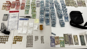 Toronto police release a photo of drugs, a replica gun and proceeds allegedly obtained by crime following a search warrant investigation in a downtown encampment. (Toronto police)