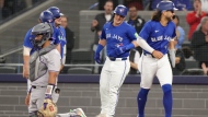 Toronto Blue Jays' Daulton Varsho, centre, celebrates at the plate after hitting a grand slam home run off Colorado Rockies pitcher Dakota Hudson during first inning interleague MLB baseball action in Toronto, Saturday, April 13, 2024. THE CANADIAN PRESS/Chris Young 