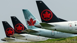 FILE - Grounded Air Canada planes sit on the tarmac at Pearson International Airport during the COVID-19 pandemic in Toronto on Wednesday, April 28, 2021. THE CANADIAN PRESS/Nathan Denette 