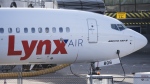 A Lynx Air Boeing 737 jet sits at a gate at the international airport in Calgary on Friday, February 23, 2024. THE CANADIAN PRESS/Todd Korol 