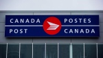 FILE - The Canada Post logo is seen on the outside the company's Pacific Processing Centre, in Richmond, B.C., on June 1, 2017. THE CANADIAN PRESS/Darryl Dyck 