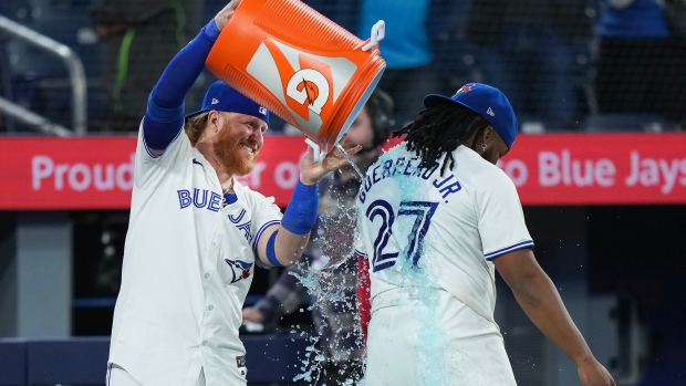 Toronto Blue Jays' Justin Turner (2) douses Vladimir Guerrero Jr. (27) after defeating the New York Yankees in American League MLB baseball action in Toronto on Tuesday, April 16, 2024. THE CANADIAN PRESS/Nathan Denette