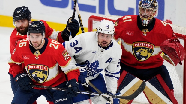 Florida Panthers goaltender Anthony Stolarz (41) looks on as Toronto Maple Leafs' Auston Matthews (34) battles with Panthers' Jonah Gadjovich (12) and Uvis Balinskis (26) during first period NHL hockey action in Sunrise, Fla. on Tuesday, April 16, 2024. THE CANADIAN PRESS/Frank Gunn