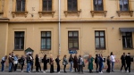 Voters wait near a polling station in Zagreb, Croatia, Wednesday, April 17, 2024. (AP Photo/Darko Bandic)