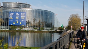 A man rides his bicycle next to the European Parliament Thursday, April 11, 2024 in Strasbourg, eastern France. The European Elections will take place from June 6 to June 9 2024. (AP Photo/Jean-Francois Badias)