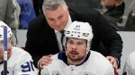 Toronto Maple Leafs head coach Sheldon Keefe speaks with Auston Matthews (34) during third period NHL hockey action against the Tampa Bay Lightning in Tampa, Fla. on Wednesday, April 17, 2024. THE CANADIAN PRESS/Frank Gunn