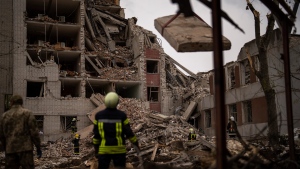 Firefighters work on a building that was partially destroyed after a Russian bombardment in Chernihiv, Ukraine, Wednesday, April 17, 2024. (AP Photo/Francisco Seco)