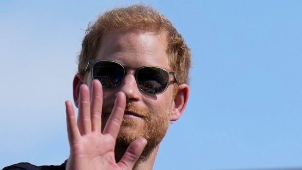 FILE - Britain's Prince Harry, the Duke of Sussex, waves during the Formula One U.S. Grand Prix auto race at Circuit of the Americas, on Oct. 22, 2023, in Austin, Texas. Prince Harry, the son of King Charles III and fifth in line to the British throne, has formally confirmed his is now a U.S. resident. (AP Photo/Nick Didlick, File)