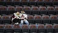Arizona Coyotes fans sit in their seats long after the team's NHL hockey game against the Edmonton Oilers ended, Wednesday, April 17, 2024, in Tempe, Ariz. (AP Photo/Ross D. Franklin)