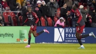 Toronto FC's Tyrese Spicer (left) celebrates his goal against Atlanta United with teammate Aime Mabika during first half MLS soccer action in Toronto on Saturday, March 23, 2024. Everything is new these days for Spicer, from scoring his first MLS goal to seeing himself in a video game. THE CANADIAN PRESS/Arlyn McAdorey
