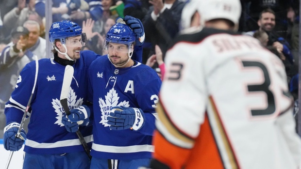 Toronto Maple Leafs' Auston Matthews (centre) is congratulated by Simon Benoit after scoring his third goal against the Anaheim Ducks during second period NHL hockey action in Toronto, on Saturday, February 17, 2024. Benoit, who grew up in the Montreal suburb of Laval, recalls watching his Canadiens go on a couple playoff runs when he was a kid. THE CANADIAN PRESS/Chris Young