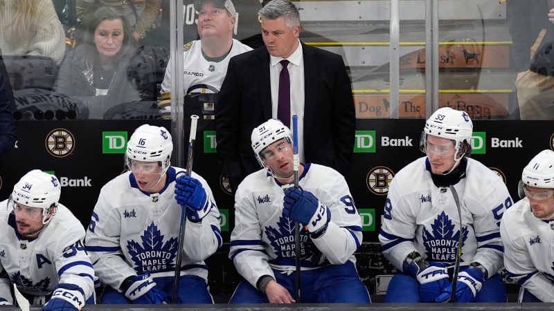 Toronto Maple Leafs coach Sheldon Keefe watches play during the third period in Game 1 of the team's NHL hockey Stanley Cup first-round playoff series against the Boston Bruins, Saturday, April 20, 2024, in Boston. (AP Photo/Michael Dwyer)