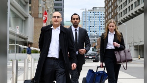 Umar Zameer and his lawyers walk away from the courthouse following his not guilty verdict, in Toronto, Sunday, April 21, 2024. THE CANADIAN PRESS/Christopher Katsarov