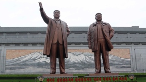 Citizens pay tribute to the statues of their late leaders Kim Il Sung, left, and Kim Jong Il in Pyongyang, North Korea Monday, April 15, 2024. (AP Photo/Cha Song Ho)