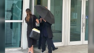 Celebrity handbag designer Nancy Gonzalez hides under an umbrella as she walks with her lawyer Andrea Lopez outside the federal courthouse Monday, April 22, 2024, in Miami. The Colombian designer, whose bags were purchased by celebrities like Britney Spears and the cast of the "Sex and the City" TV series, was sentenced to 18 months in federal prison on Monday for leading a smuggling ring that illegally imported into the U.S. crocodile handbags for sale at high end showrooms using couriers on commercial flights. (AP Photo/Josh Goodman)