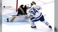Toronto Maple Leafs center Auston Matthews (34) beats Boston Bruins goaltender Linus Ullmark, back, for a goal during the third period of Game 2 of an NHL hockey Stanley Cup first-round playoff series, Monday, April 22, 2024, in Boston. THE CANADIAN PRESS/AP-Charles Krupa