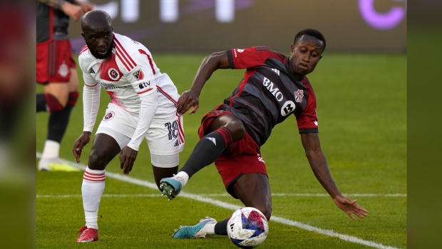 Toronto FC midfielder Richie Laryea (22) vies for the ball with New England Revolution midfielder Ema Boateng (18) during MLS soccer action in Toronto on Saturday May 6, 2023. Toronto FC is in discussions to bring in a player and to move one out in advance of Tuesday's closing of the MLS's primary transfer window.THE CANADIAN PRESS/Frank Gunn