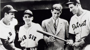 John F. Kennedy looks at a bat with baseball greats, from left, Ted Williams, Eddie Pellagrini and Hank Greenberg in this photo dated April, 1946. (AP Photo / HO courtesy of John F. Kennedy Presidential Library)