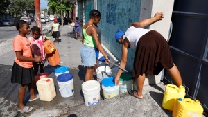 Residents fill their containers with potable water, in Port-au-Prince, Haiti, Friday, March 8, 2024. (Odelyn Joseph / AP Photo)