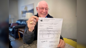 Blake Kent holds the property tax bill for $0.05. (CTV News/Spencer Turcotte)