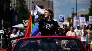 Parade grand marshal Fae Johnstone calls out chants through a megaphone  during the Capital Pride Parade in Ottawa, on Sunday, Aug. 27, 2023. Organizations across the country are gearing up for what they describe as the largest LGBTQ+ mobilization since the push for marriage equality. THE CANADIAN PRESS/Justin Tang
