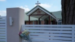 Flowers sit on a fence outside the Christ the Good Shepherd church in western Sydney, Australia, on April 16, 2024. (AP Photo/Mark Baker, File)