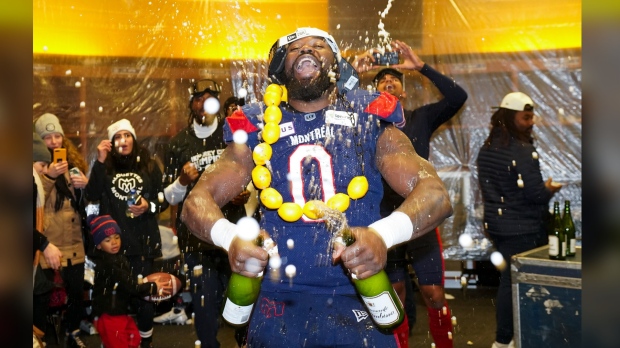 Montreal Alouettes defensive end Shawn Lemon (0) celebrates in the dressing room after the Alouettes defeated the Winnipeg Blue Bombers to win the 110th CFL Grey Cup in Hamilton, Ont., on Sunday, Nov.19, 2023. The CFL has suspended veteran defensive lineman Lemon indefinitely for betting on league games.Lemon, a three-time Grey Cup champion, retired April 10. THE CANADIAN PRESS/Nathan Denette