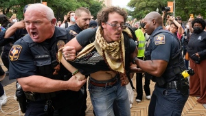 University of Texas police officers arrest a man at a pro-Palestinian protest on campus, Wednesday April 24, 2024, in Austin, Texas. (Jay Janner / Austin American-Statesman via AP)