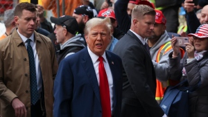 Former U.S. president Donald Trump reacts while meeting with construction workers at the construction site of the new JPMorgan Chase headquarters in midtown Manhattan, New York, April 25, 2024. (AP Photo/Yuki Iwamura)