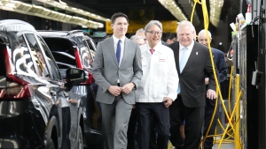 Prime Minister Justin Trudeau (left to right), Honda executive Toshihiro Mibe and Ontario Premier Doug Ford walk along an assembly line at an event announcing plans for a Honda electric vehicle battery plant in Alliston, Ont. on Thursday, April 25, 2024. THE CANADIAN PRESS/Nathan Denette