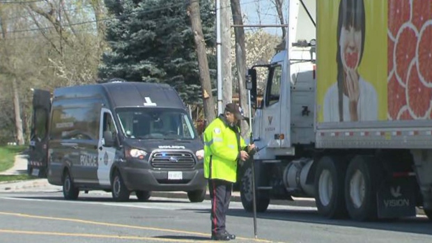 Police are shown at a scene near Albion Road and Elmhurst Drive where a child was struck by a transport truck on April 26. (CP24)