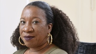 FILE - Tarana Burke, founder and leader of the #MeToo movement, sits in her home in Baltimore on Tuesday, Oct. 13, 2020. (AP Photo/Steve Ruark, File)