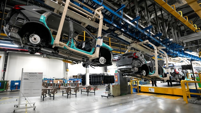 Honda employees work along the vehicle assembly line before an event announcing plans for a Honda electric vehicle battery plant in Alliston, Ont., on Thursday, April 25, 2024. THE CANADIAN PRESS/Nathan Denette
