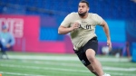 Illinois offensive lineman Isaiah Adams runs a drill at the NFL football scouting combine, Sunday, March 3, 2024, in Indianapolis. (AP Photo/Michael Conroy)