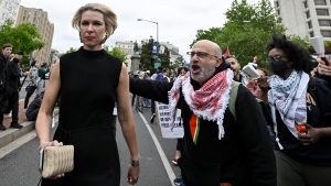 Demonstrators protest the Israel-Hamas war as a guest, left, arrives at the White House Correspondents' Association Dinner at the Washington Hilton, Saturday April 27, 2024, in Washington. (AP Photo/Terrance Williams)