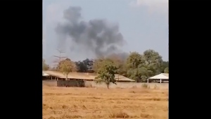 In this image from a video, smoke rises above a distant base, seen from Chbar Mon district in Kompong Speu province, Cambodia Saturday, April 27, 2024. (Chim Sothea via AP)