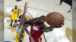 FILE - New Orleans Pelicans forward Zion Williamson (1) goes to the basket against Los Angeles Lakers forward Anthony Davis and forward Taurean Prince in the first half of an NBA basketball play-in tournament game Tuesday, April 16, 2024, in New Orleans. Looking on at rear left is Lakers' LeBron James.(AP Photo/Gerald Herbert)