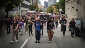 Drug user advocates are raising concerns over British Columbia's request for Health Canada to give police power to step in when they see illicit drug use in public spaces, saying it may be a step backward in the fight against the deadly opioid crisis. Andrew Leavens, front left, and Carl Gladue, front right, carry an empty coffin during a march organized by the Vancouver Area Network of Drug Users (VANDU) to mark International Overdose Awareness Day, in Vancouver, B.C., Thursday, Aug. 31, 2023. THE CANADIAN PRESS/Darryl Dyck