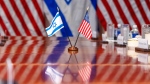 An Israeli and U.S. flag are reflected on a conference table at the Pentagon, Tuesday, March 26, 2024, in Washington. (AP Photo/Jacquelyn Martin)