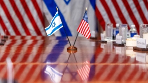 An Israeli and U.S. flag are reflected on a conference table at the Pentagon, Tuesday, March 26, 2024, in Washington. (AP Photo/Jacquelyn Martin)