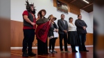 Matsqui drummer and singer Ron Francis-Modeste, left to right, and Melissa Epp, perform a song as Chief of the Matsqui Nation, Alice McKay, Minister of Crown-Indigenous Relations Gary Anandasangaree, Councillor of the Matsqui Nation Brenda Lynn Morgan, and Aboriginal Affairs of the Matsqui Nation Stanley Morgan listen during a news conference on the Matsqui First Nation in Abbotsford, B.C., on Wednesday, Feb. 21, 2024. THE CANADIAN PRESS/Ethan Cairns