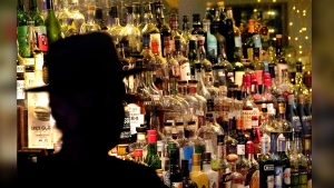 FILE - Bottles of alcohol sit on shelves at a bar in Houston on June 23, 2020. Moderate drinking was once thought to have benefits for the heart, but better research methods starting in the 2010s have thrown cold water on that. (AP Photo/David J. Phillip, File)