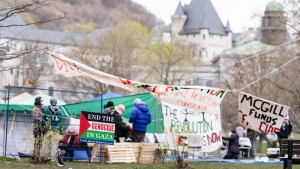 Pro-Palestinian activists are seen in their encampment set up on McGill University's campus in Montreal, Monday, April 29, 2024. The university says it will make efforts to de-escalate before asking for police help with a camp that's been set up on campus by pro-Palestinian activists. THE CANADIAN PRESS/Christinne Muschi
